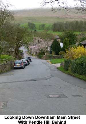 Looking down the main street of Downham with Pendle Hill behind.