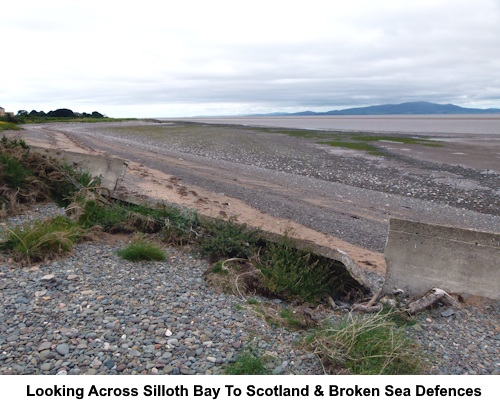 Looking across the bat to Scotland and broken sea defences.