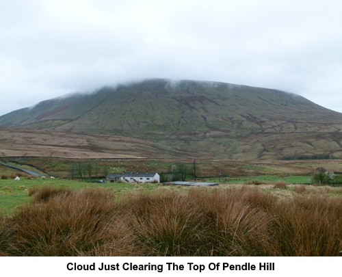 Cloud just clearing the top of Pendle Hill.