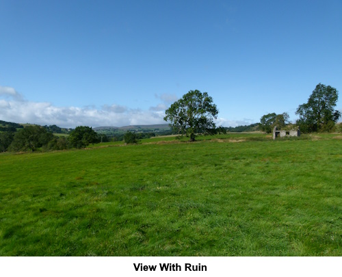 A view including a ruined barn.