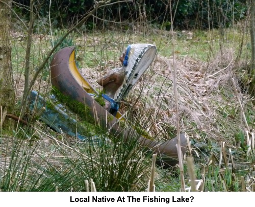 A canoe and statue of American Indian at the fishing lake.