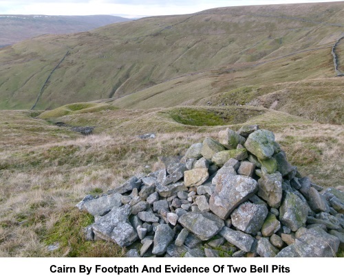 Cairn by the footpath and remains of bell pits.